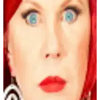 a woman with red hair and blue eyes has a surprised look on her face .