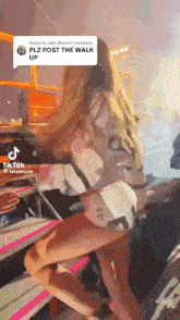 a tiktok video of a woman sitting on a chair with a reply to jake shane 's comment