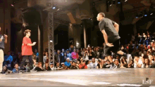 a man in a black shirt is dancing in front of a crowd with lsf written on the bottom