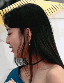 a close up of a woman 's face with a choker and earrings