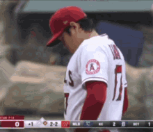 a baseball player with the number 11 on his jersey looks down