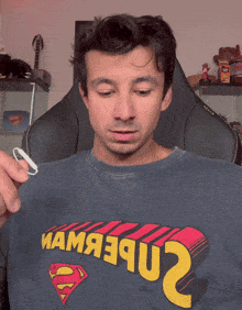 a man wearing a superman t-shirt with the number 2 on the front