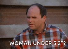 a man in a plaid shirt is talking about a woman under 5 ' 2 " .