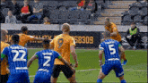 a group of soccer players on a field with one wearing the number 9