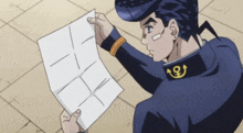 a man with a bandage on his face is holding a piece of paper with lines drawn on it