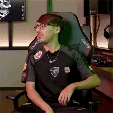 a man is sitting in a gaming chair with a shirt that says burger king on it