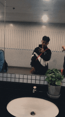 a man taking a picture of himself in a mirror