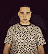 a man wearing a black and white t-shirt with a geometric pattern on it