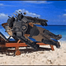 a robot is laying on the beach with sunglasses on his head