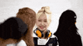 a girl wearing headphones has a tag that says really really