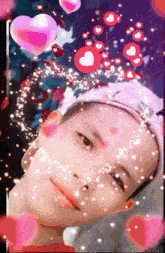 a boy 's face is surrounded by pink hearts