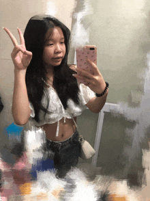a girl taking a picture of herself with her phone