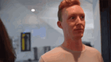 a close up of a man 's face with red hair