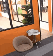 a chair is sitting in a room next to a small table .