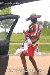 a person in a sombrero is dancing in the back of a car .