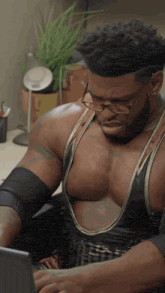 a man wearing glasses and a tank top that says ' hulk ' on it