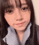 a close up of a woman 's face with a sweater on