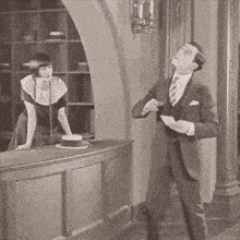 a man in a suit and tie stands next to a woman in a hat