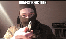 a man wearing a mask is holding a knife with the words honest reaction below him