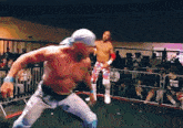two wrestlers in a ring with one wearing a shirt that says ' i love nyc ' on it