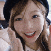 a close up of a woman 's face with a hat on