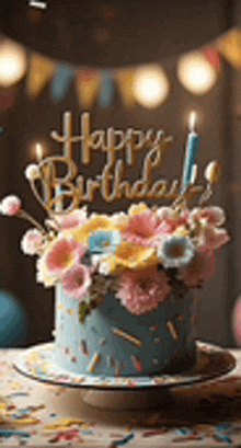 a blue birthday cake with flowers and candles on top of it .