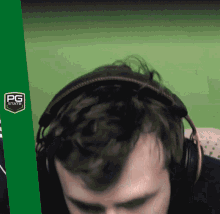 a man wearing headphones with a pg stats logo on the bottom