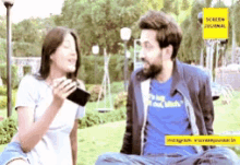 a man and a woman are sitting in a park talking
