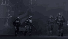 a group of soldiers are standing next to each other in a dark room
