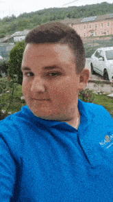 a man wearing a blue shirt that says aga on the front