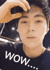 a close up of a man 's face with the words wow written on it
