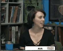 a woman named ava is sitting in front of a bookcase