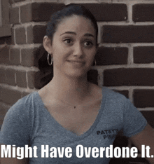 a woman standing in front of a brick wall with the words might have overdone it