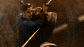 a man with a beard is holding a sword