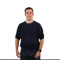 a man wearing a watch and a blue sweater is making a funny face
