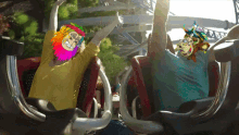 two people are riding a roller coaster and one has a colorful mask on