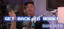 a man is talking into a microphone with the words get back to work dark web behind him