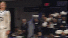 a blurry photo of a basketball game with a player wearing the number 23