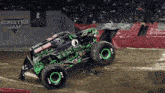 a monster jam truck is driving through the mud