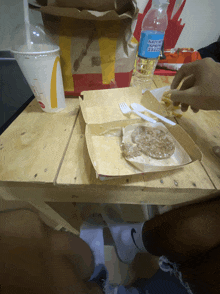 a bottle of nature 's choice water sits on a table next to a mcdonald 's bag