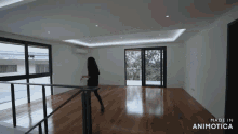 a woman is standing on a railing in an empty room made in animatica