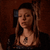 a woman with a necklace says fine thanks umm...