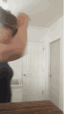 a blurry picture of a woman standing in front of a mirror