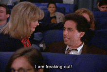 a man and a woman are sitting on a plane and the man is saying i am freaking out
