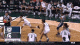 a group of basketball players are playing a game on a court