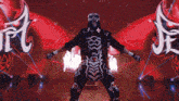 a man in a skeleton costume is dancing in front of a red background with chinese characters