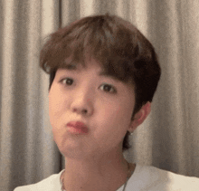 a close up of a young man making a funny face .
