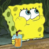 spongebob is drinking orange juice through a straw .