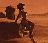 a woman in a bikini and cowboy hat leans against a car