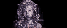 a close up of a woman 's face covered in ice .